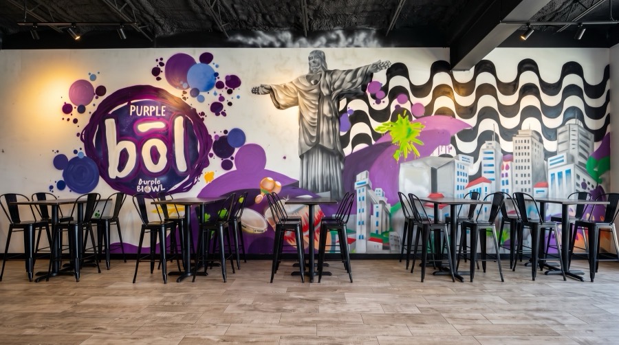 Inside Purple Bōl Açaí in Sarasota, FL — Brazilian-inspired mural and seating